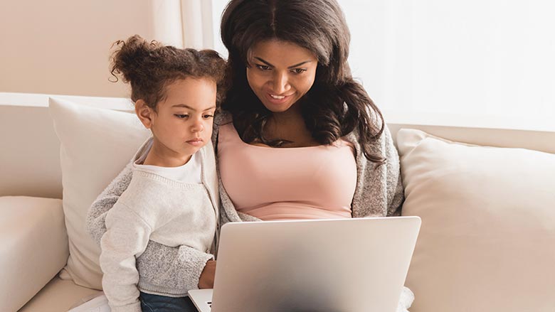 Mom with daughter using laptop