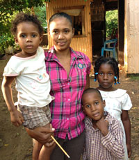 Sandra Carela Jimenez (center) is a health promoter for Niños Primeros en Salud (NPS) in the Dominican Republic, where she helps mothers raise healthier families. Her own children, Ruberky, Ruben and Rubelly (left to right) benefited from care provided by