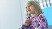 Young hospital patient clutching doll