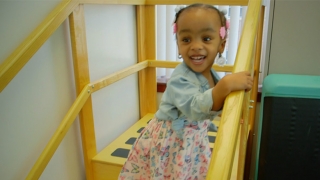 Leukodystrophy Center patient smiling standing on stairs