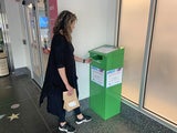 Woman places medications into a drug take-back bin at CHOP Main hospital