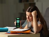 Young girl studying drinking an energy drink