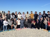 Large group of young people smiling on a beach