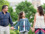 Paulina walking outside with her parents