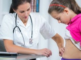 Doctor examining a child's stomach