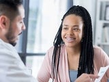 Doctor talking to teen patient