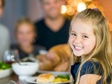 Young girl smiling at Thanksgiving table