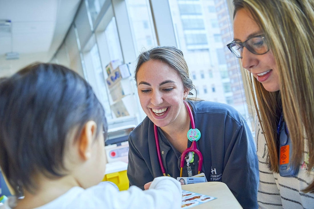 Health care staff smiling while caring for a patient