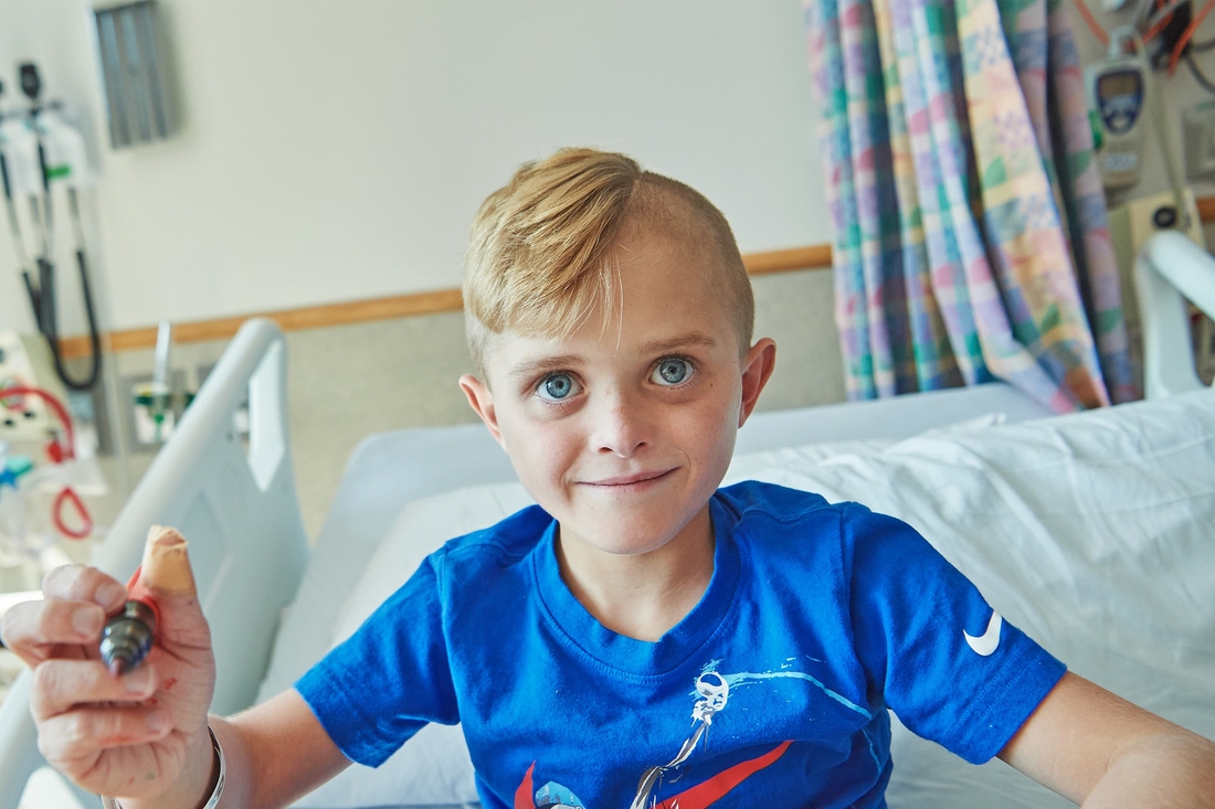 Cystic fibrosis patient smiling in hospital bed