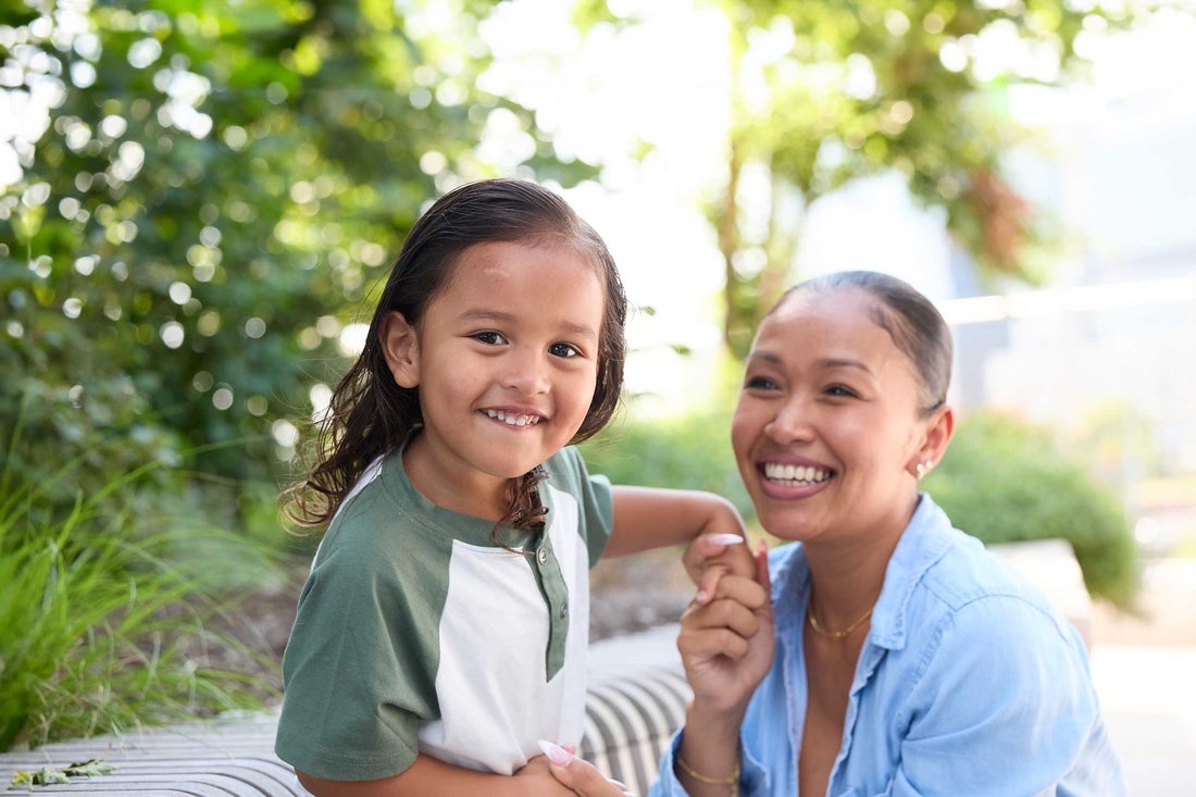 Mother in blue shirt and son in white and green shirt