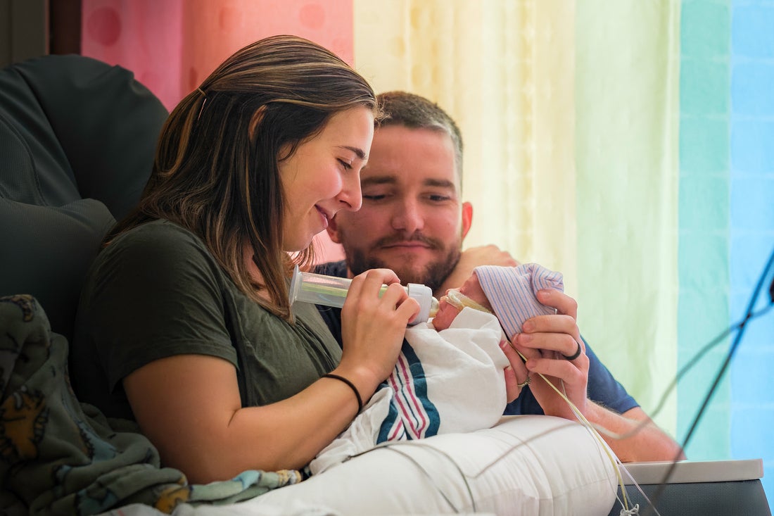 New parents admiring their delicate and mightily strong baby