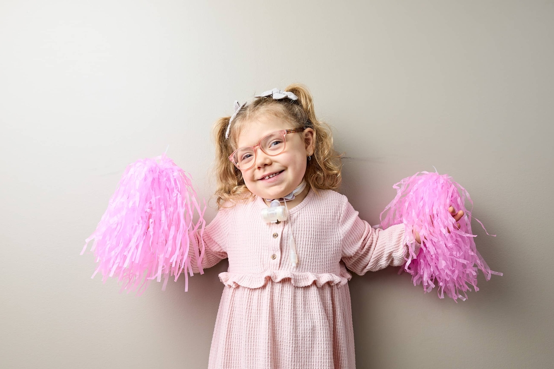 Young girl holding pom poms