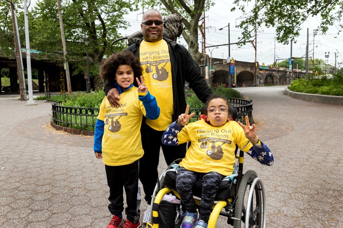 Family with girl in wheelchair at reunion for thoracic insufficiency syndrome patients.