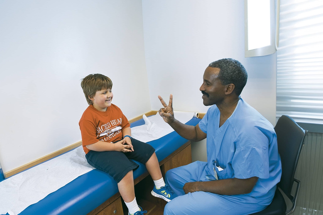 Clinician examing a patient in exam room.