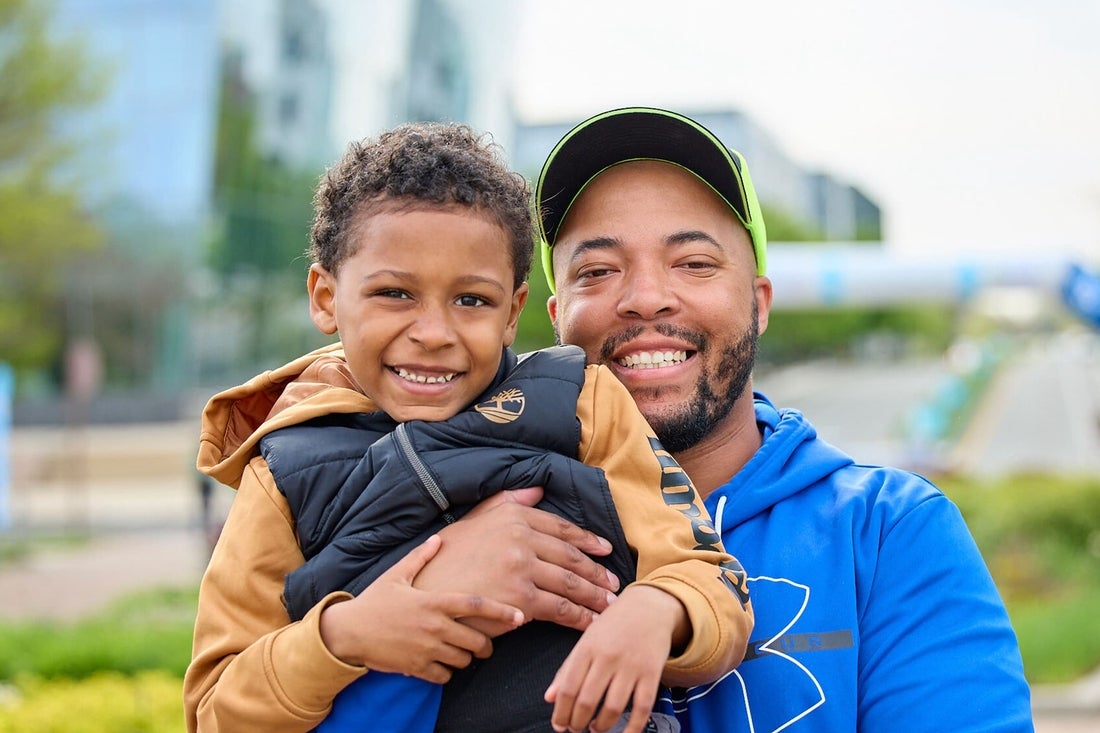 Father and son hugging outside