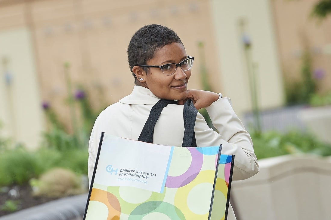 Teenaged CHOP patient holding shopping bag