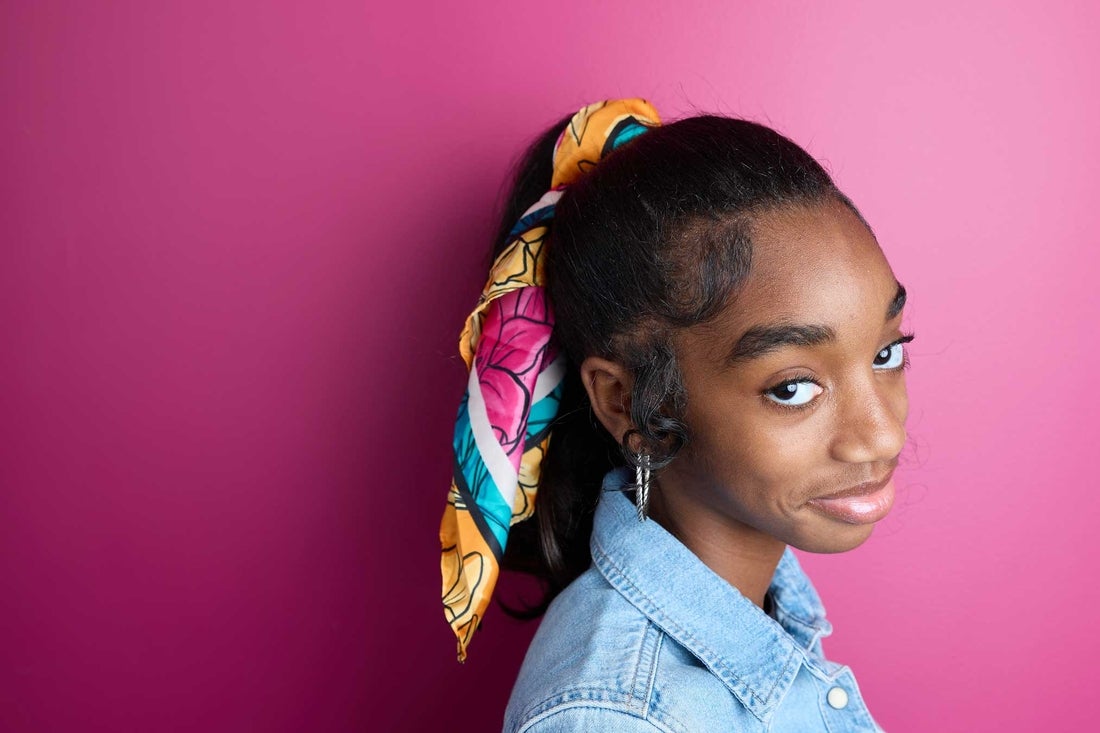 Girl in with scarf on pink background