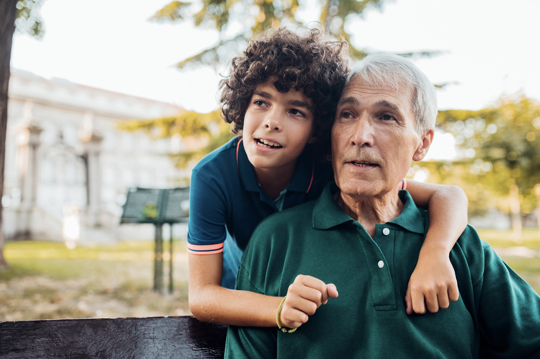 Boy hugging his grandfather