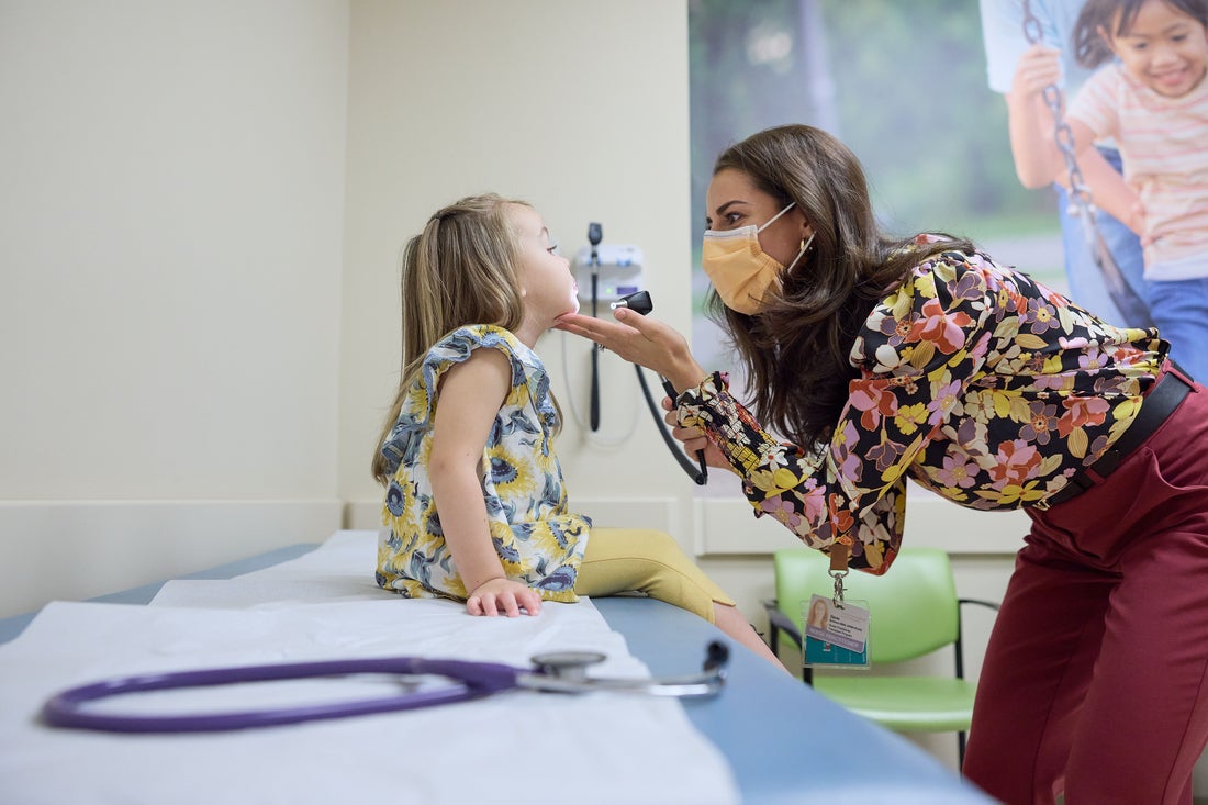 Doctor examines girl.