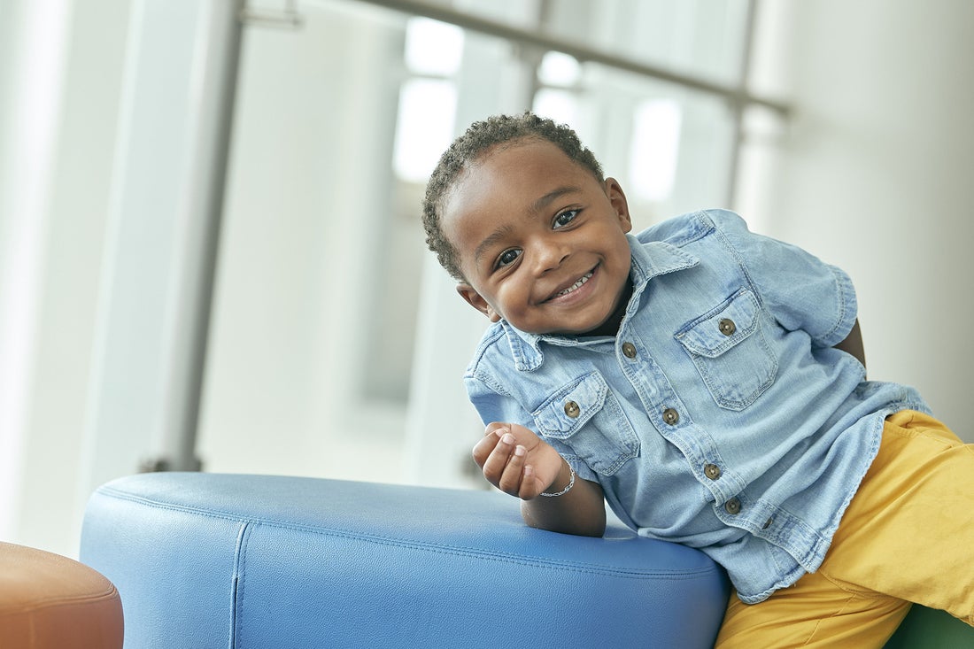 Young child leaning over and smiling