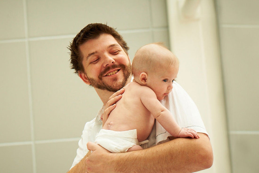 Dad holding his baby.