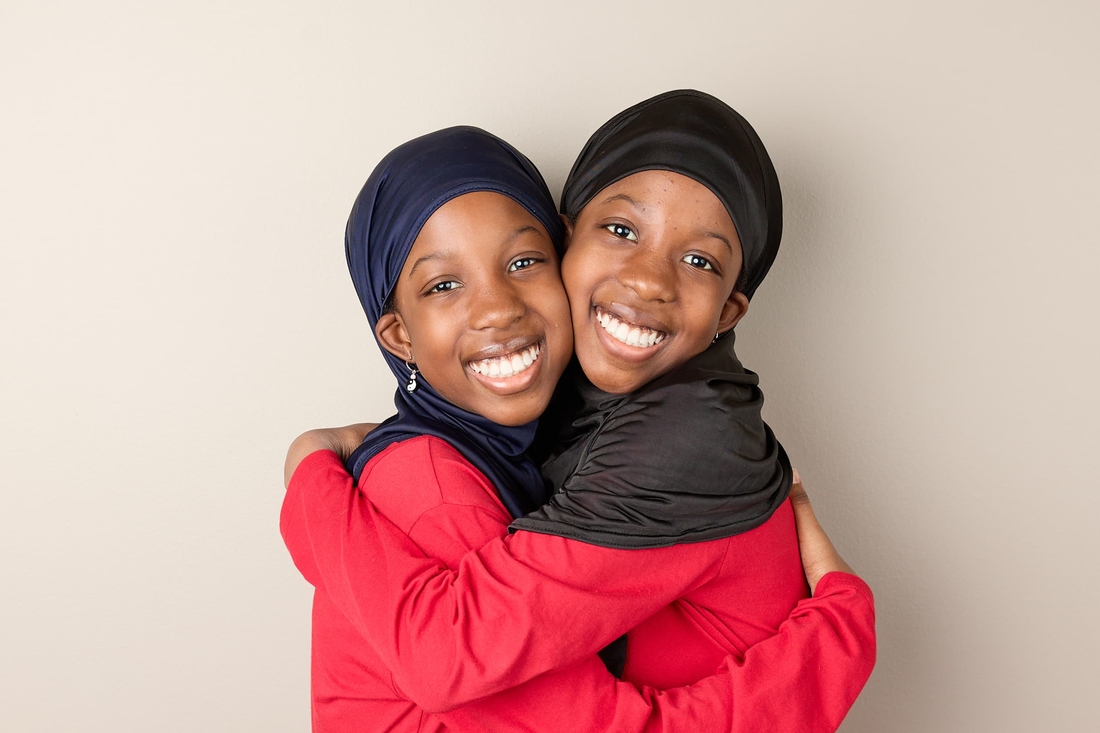 ladies smiling and hugging.