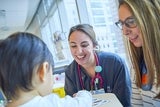 Health care staff smiling while caring for a patient