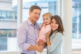 Young girl smiling with her mom and dad