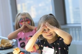 Two young patients making heart shapes with their hands