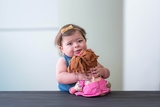 Toddler hugging her doll