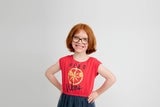 young girl standing with hands on hips smiling