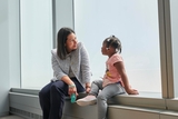 Physician talking with young patient