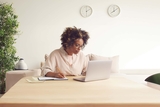 adult sitting at desk with computer