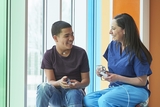 Hispanic boy laughing with pediatrician