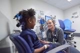 Young girl being cared for by a nurse