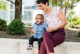 Female doctor and African American boy laughing together in the hospital garden