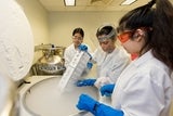 Doctor and interns in research lab extract patient-based cell lines and samples from liquid nitrogen