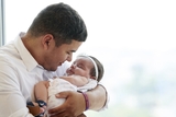 Father holding his smiling hispanic baby girl