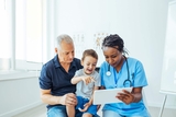 Father and son reviewing test with physician