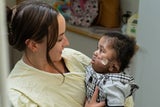 Nurse Holding an intensive care baby