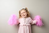 Young girl holding pom poms