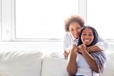 Mother smiling hugging her daughter