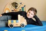 Boy leaning on his elbow with wooden blocks