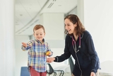 Staff member helping a patient walk