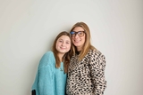 Mother in glasses and daughter in teal sweater