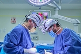 Two surgeons operating.