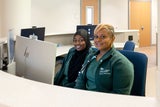 Two staff members at a check-in desk