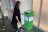 Woman places medications into a drug take-back bin at CHOP Main hospital