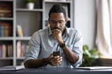 Black man looking at cell phone