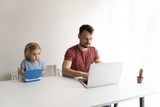 Dad and child on laptop